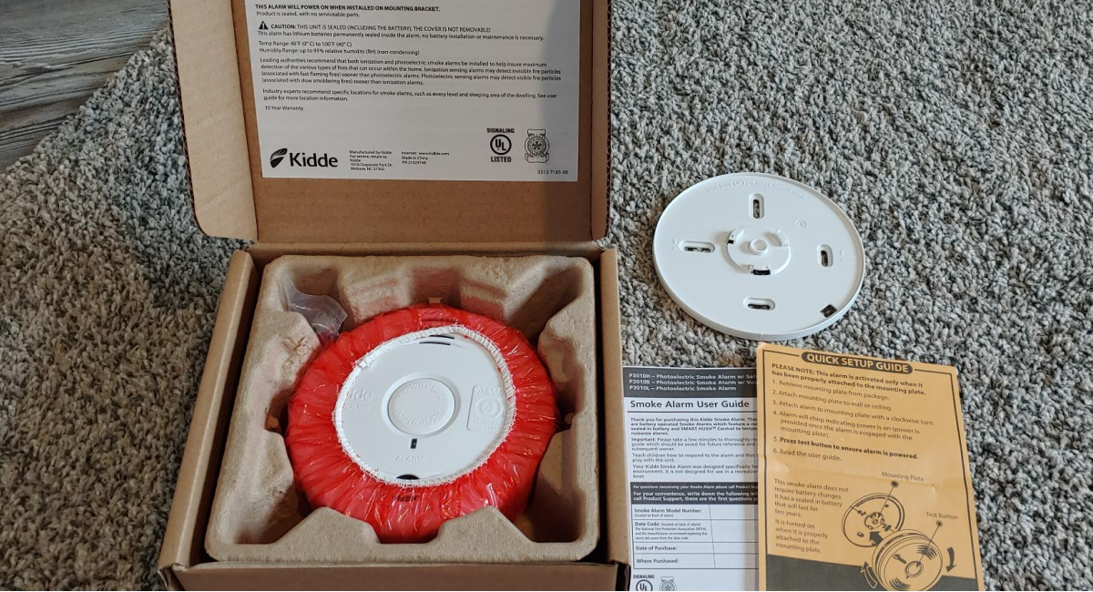 open box with Kidde Photoelectric Sensor Smoke Alarm inside and instructions outside of it