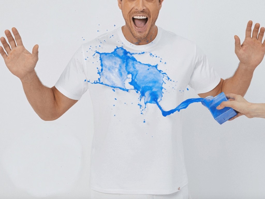 blue liquid spilling on adult shirt
