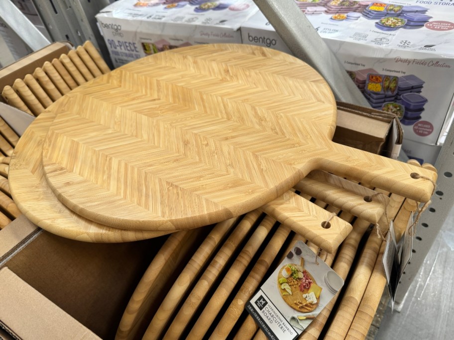 round herringbone wood cutting boards on box in store