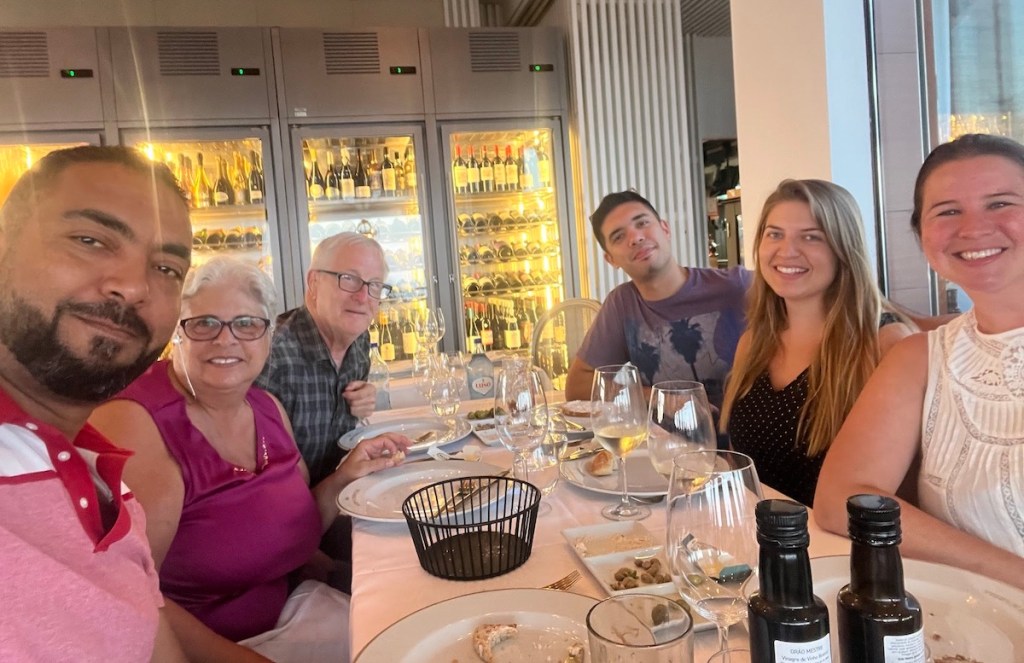 family sitting at fancy dinner table in restaurant 