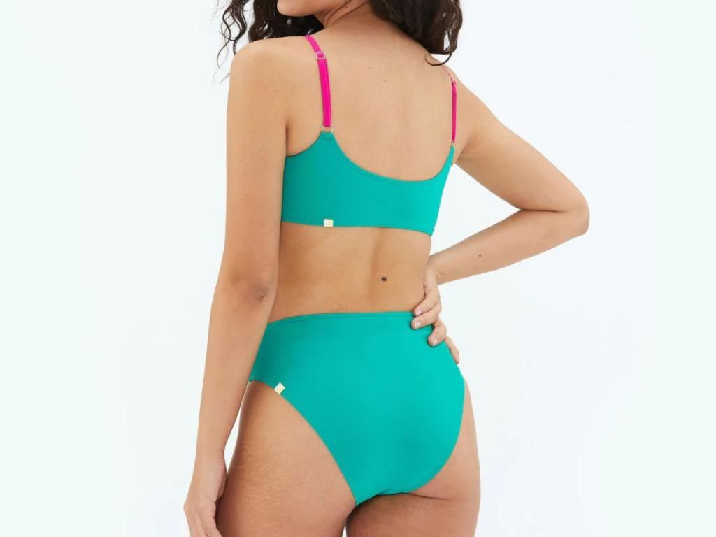 back view of woman wearing green swimsuit