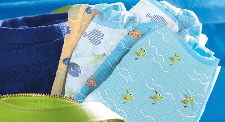 swimming diapers in three different designs showcased in a beach bag