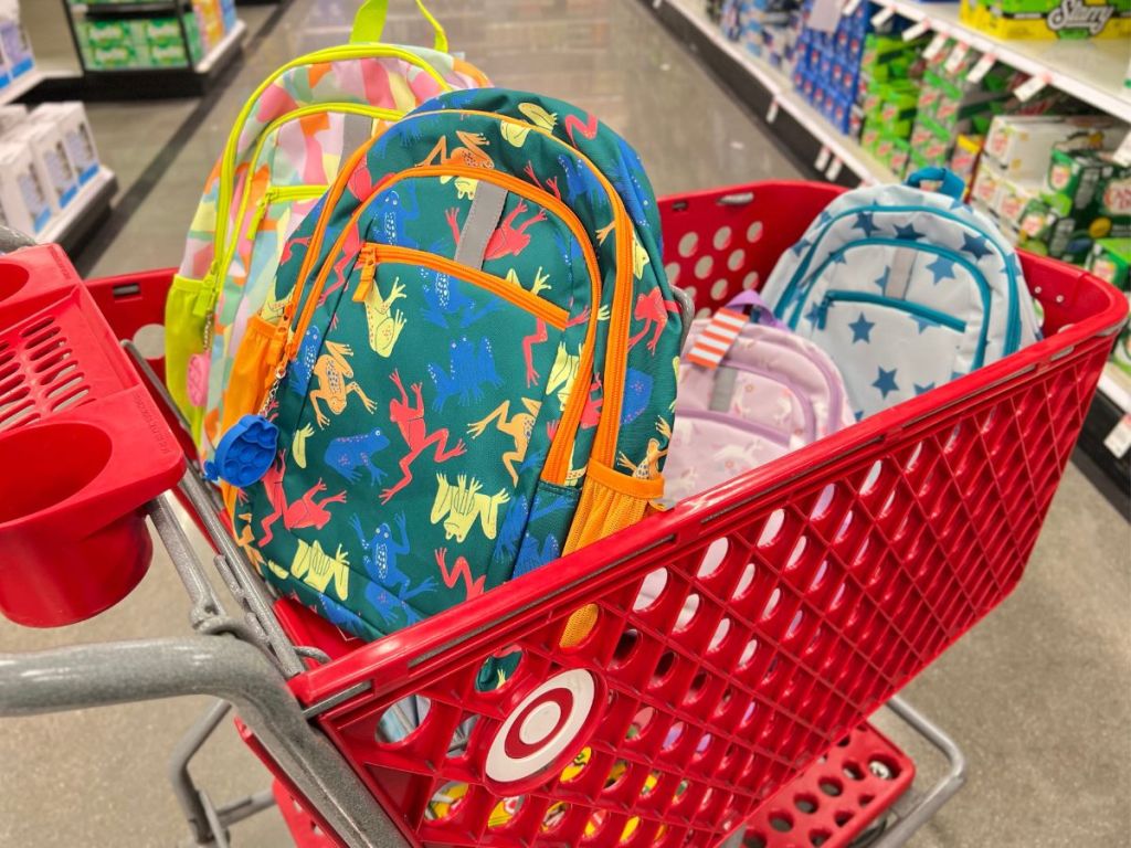 Target shopping cart filled with kids backpacks