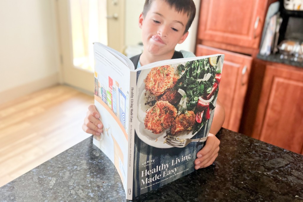 boy holding cookbook