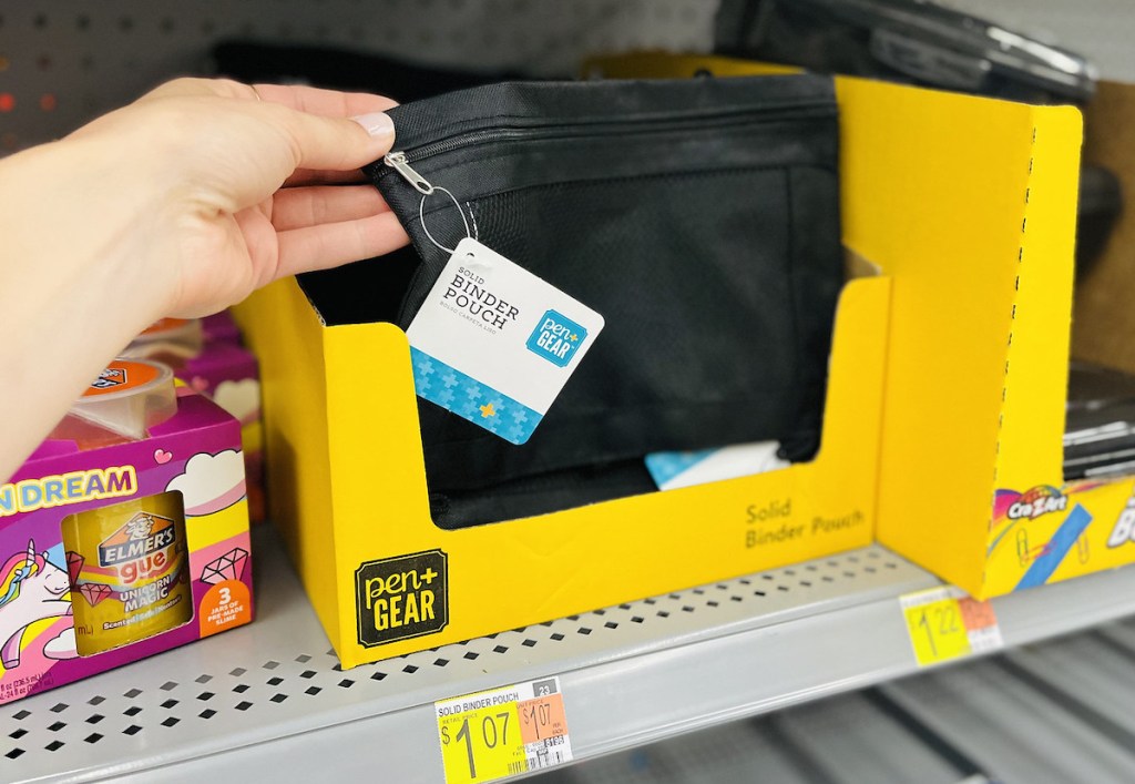 hand holding a black binder pouch on store shelf