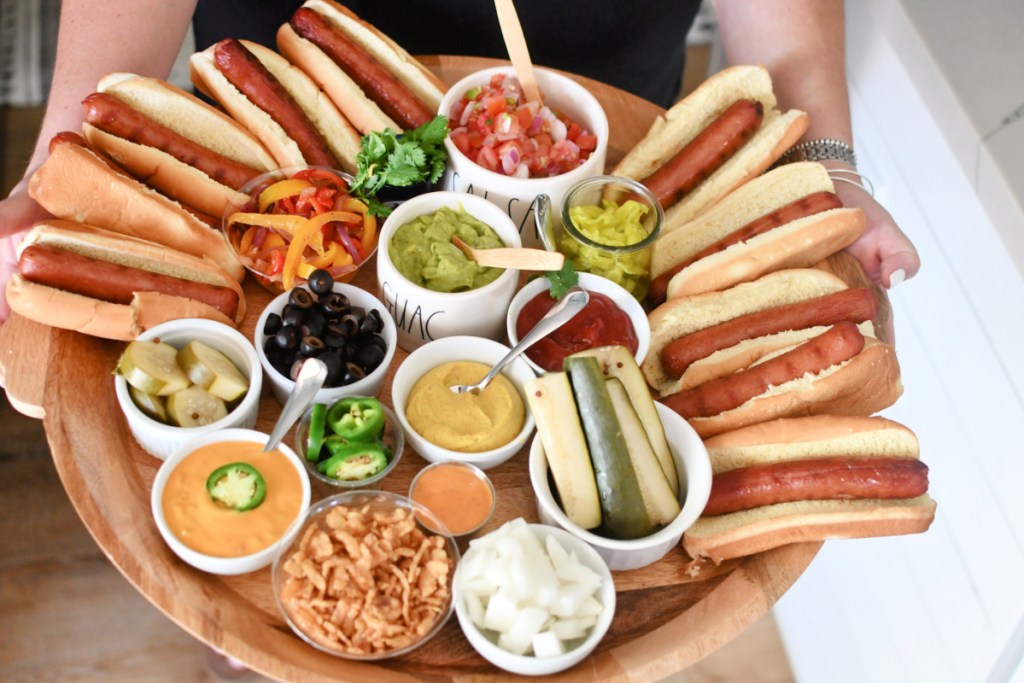 woman holding a hot dog charcuterie board