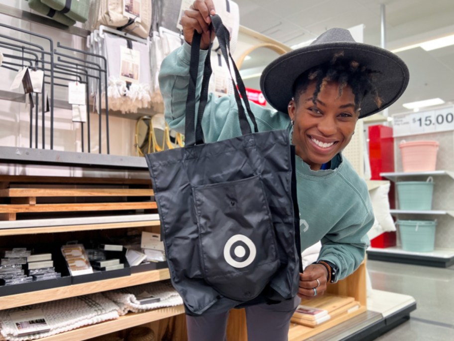 woman holding target black bag in store