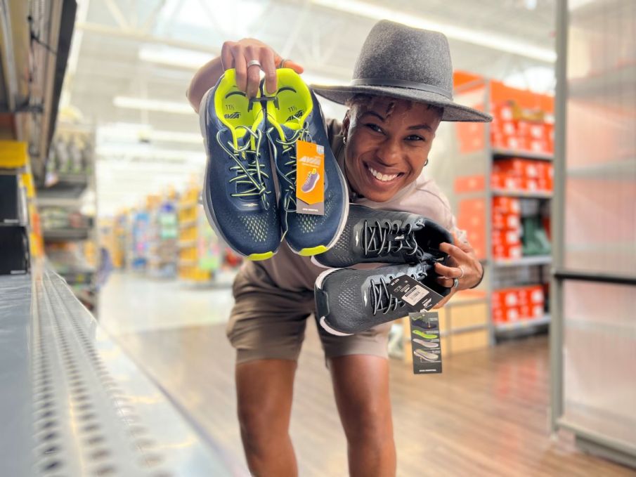 woman holding two pairs of Avia Hightail Running Shoes