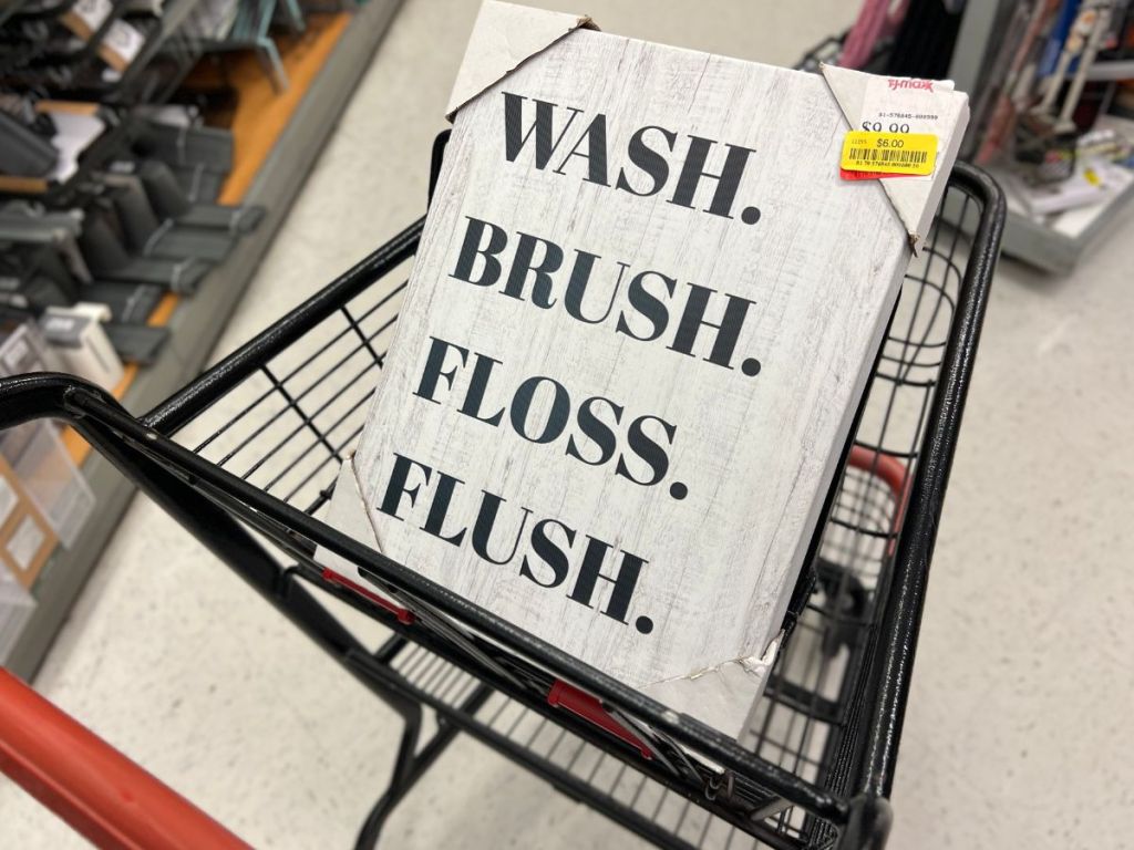 A Bathroom Sign in a cart