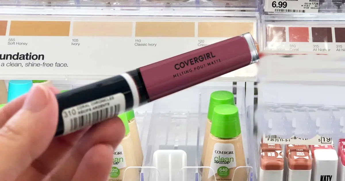 hand holding a tube of covergirl liquid lipstick