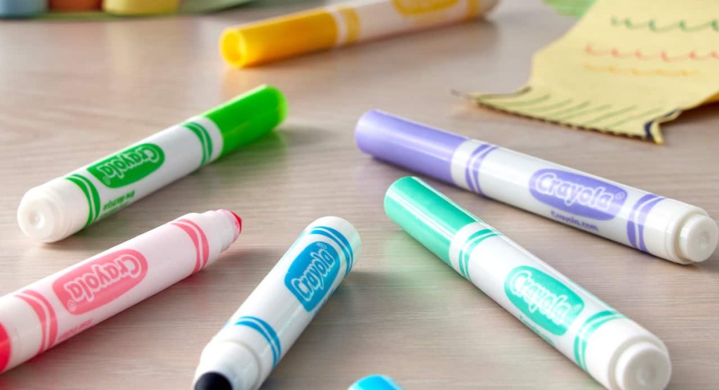 Crayola bold and bright markers displayed on the table with sticky note