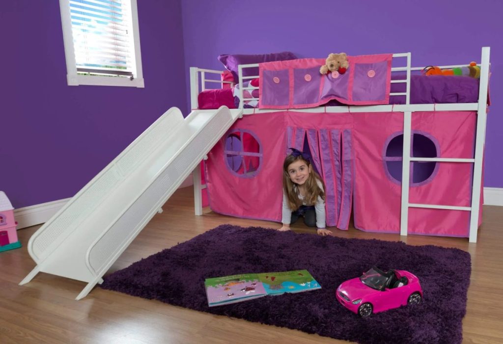 girl playing in bedroom under white loft bed with slide