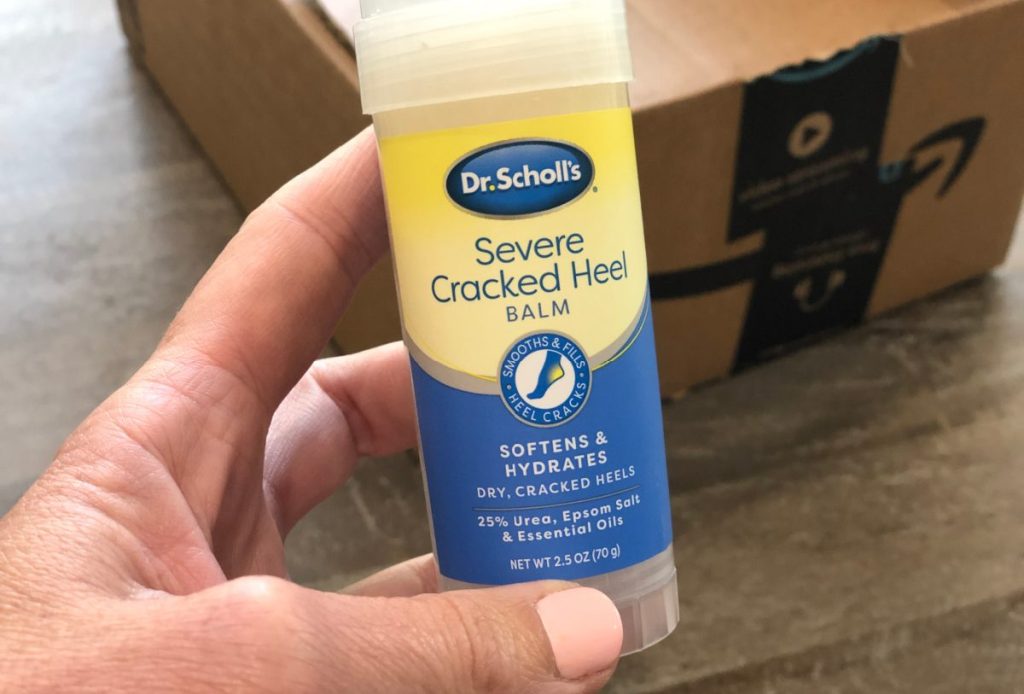 woman holding Dr. Scholl's Cracked Heel Balm