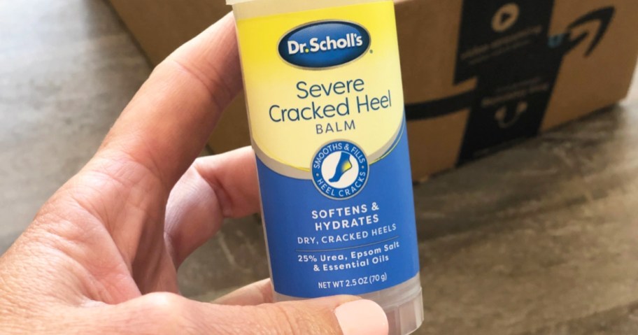 hand holding Dr. Scholl's Severe Cracked Heel Balm