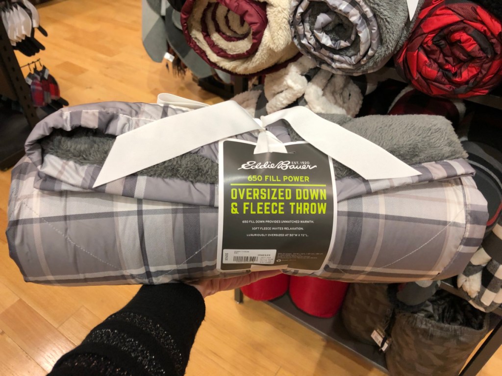 person holding Eddie Bauer Down Throws with ribbon
