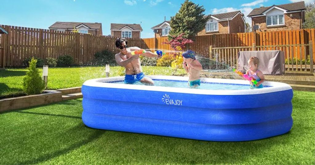 2 kids and adult man in inflatable pool outside