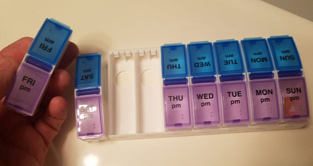 hand holding Ezy Dose Pill Organizers