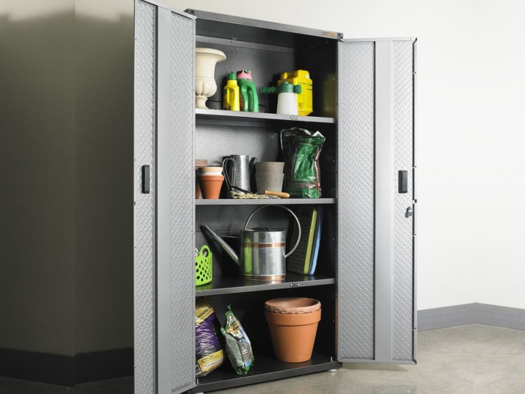silver cabinet with opened doors showing four shelves filled with gardening supplies