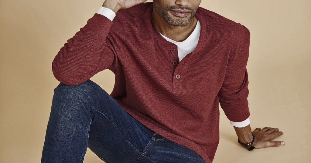 man in red henley and jeans