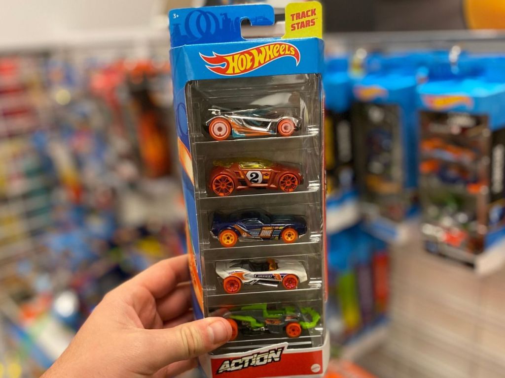 hand holding a 5 pack of hot wheels cars