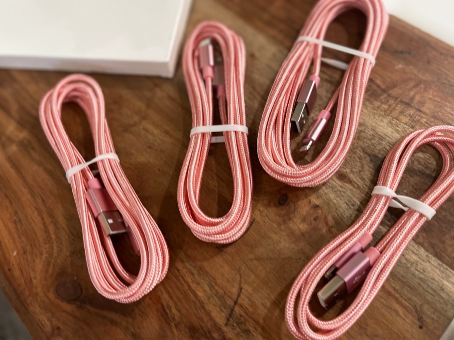 pink charging cables on wood table