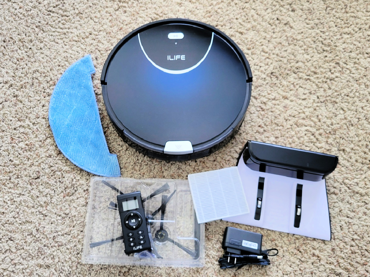 ILIFE Robot Vacuum and accessories spread across a rug