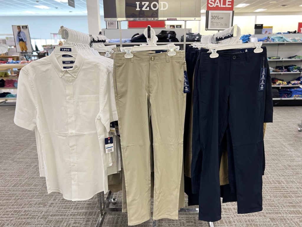 button down tee and uniform pants on display in store