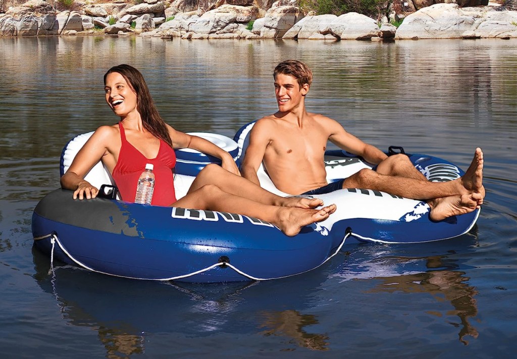 Two people on the Intex River Run II Pool Float with built in cooler which is one of the top selling Amazon pool floats