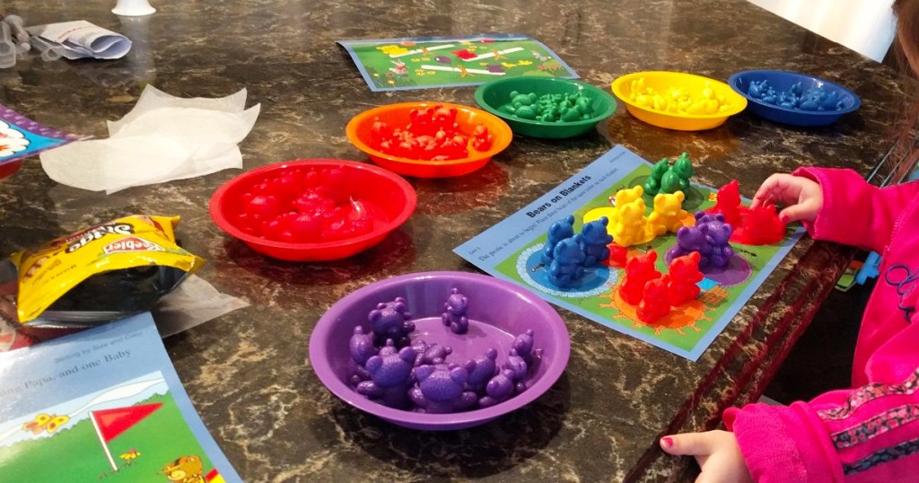 child organizing colorful bears