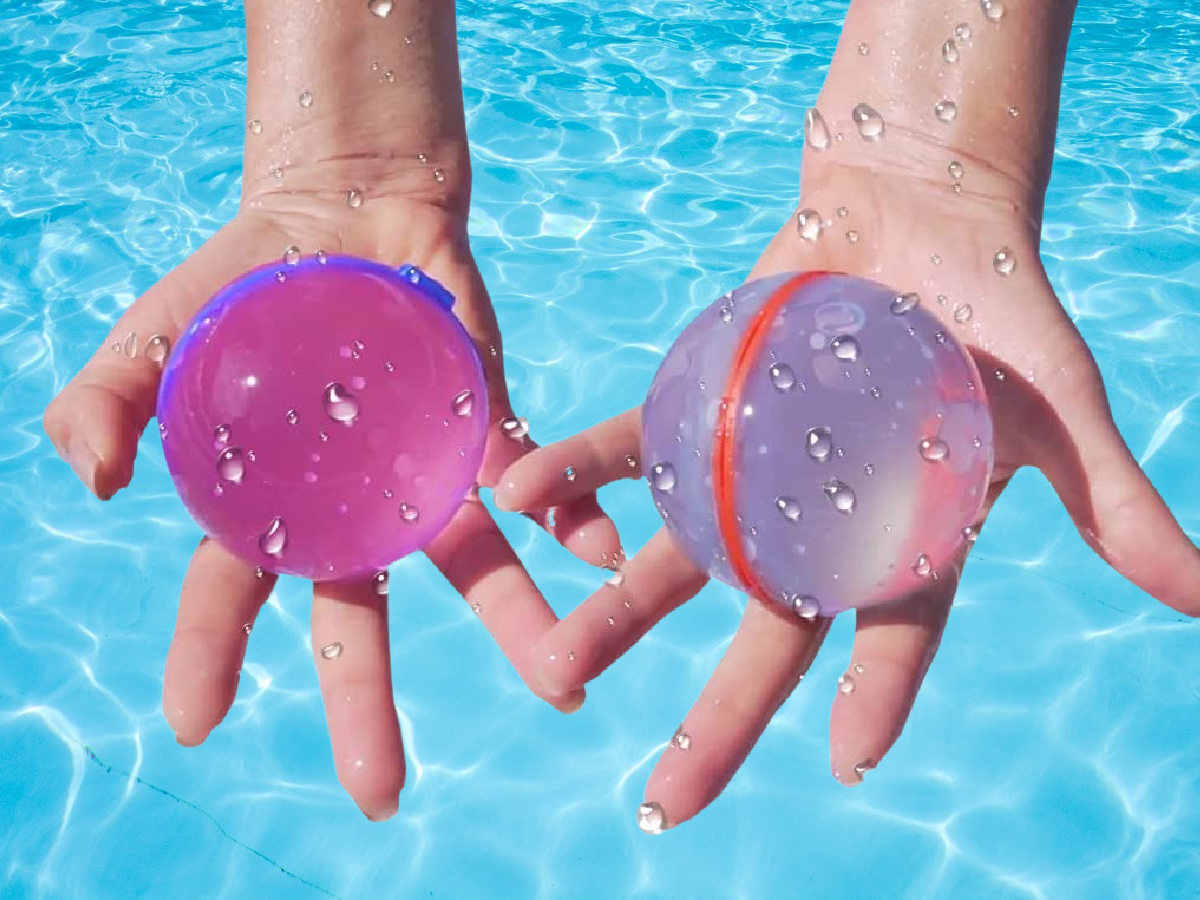pair of hands holding water balloon balls