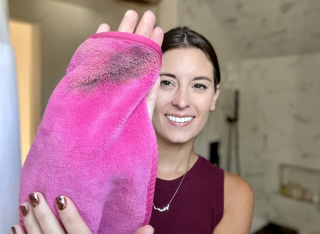 woman holding pink makeup eraser