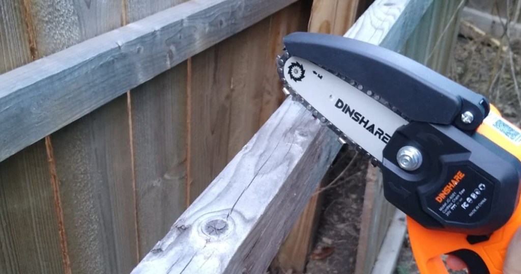 Mini chainsaw over fence