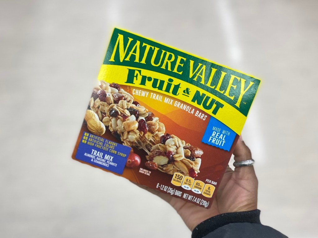Hand holding a box of Nature Valley bars
