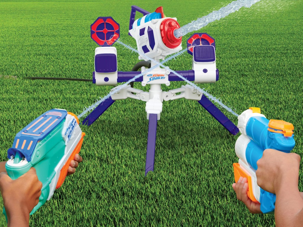 two kids shooting water blasters at water soaker toy outside
