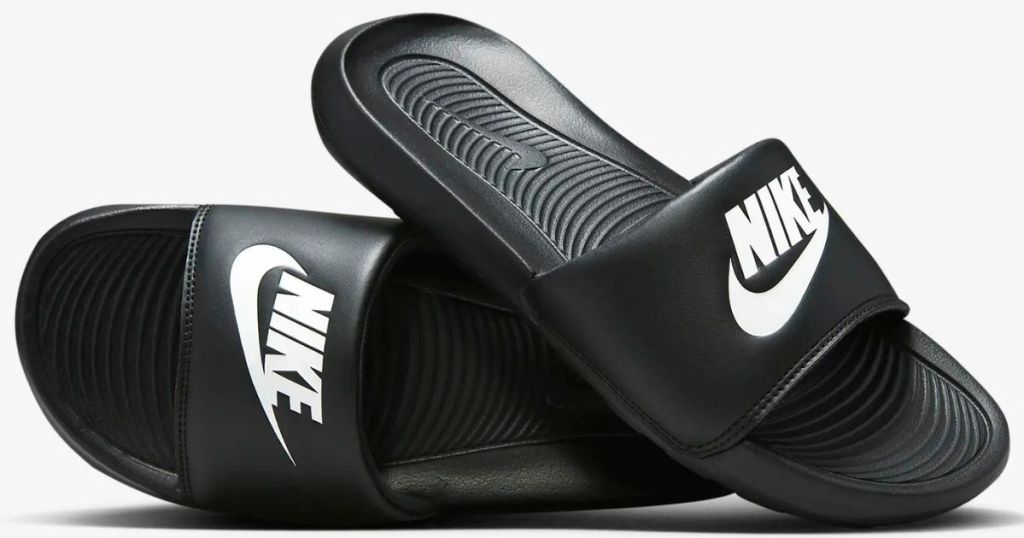 a pair of women's Nike slides in black 