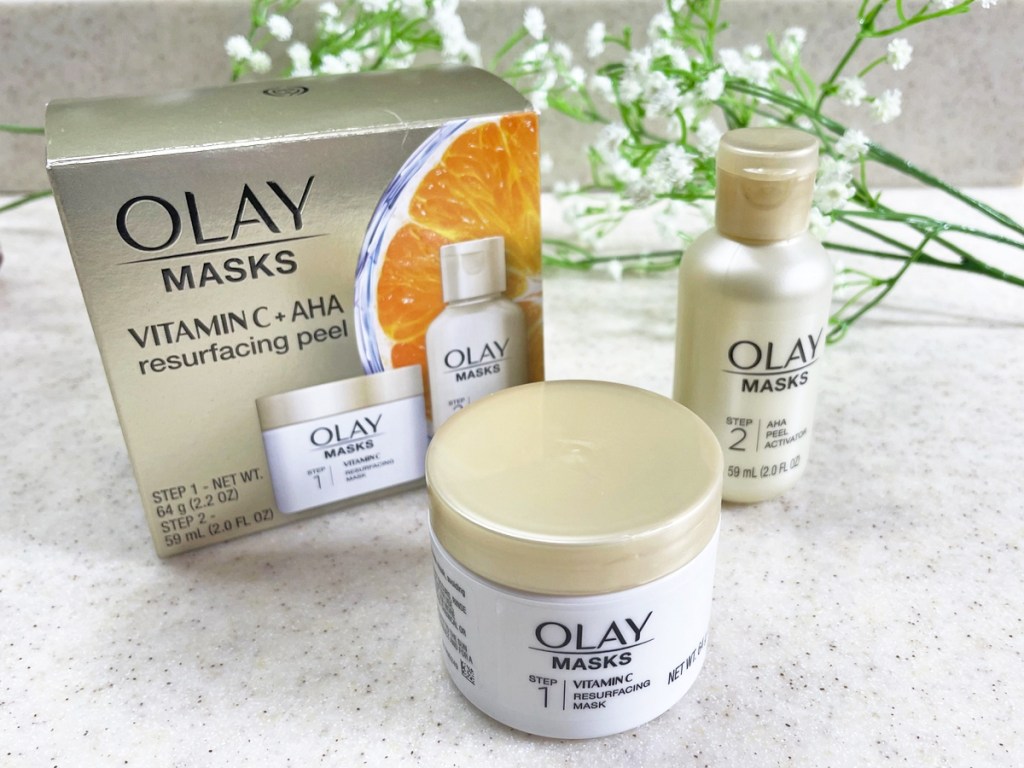 olay masks set on counter with flowers