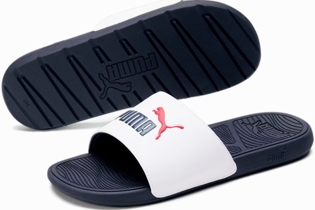 pair of navy blue and white puma slides