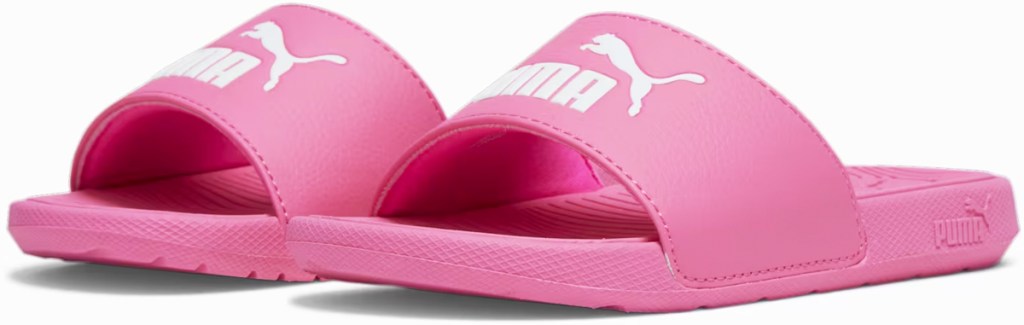 pair of pink and white puma slides