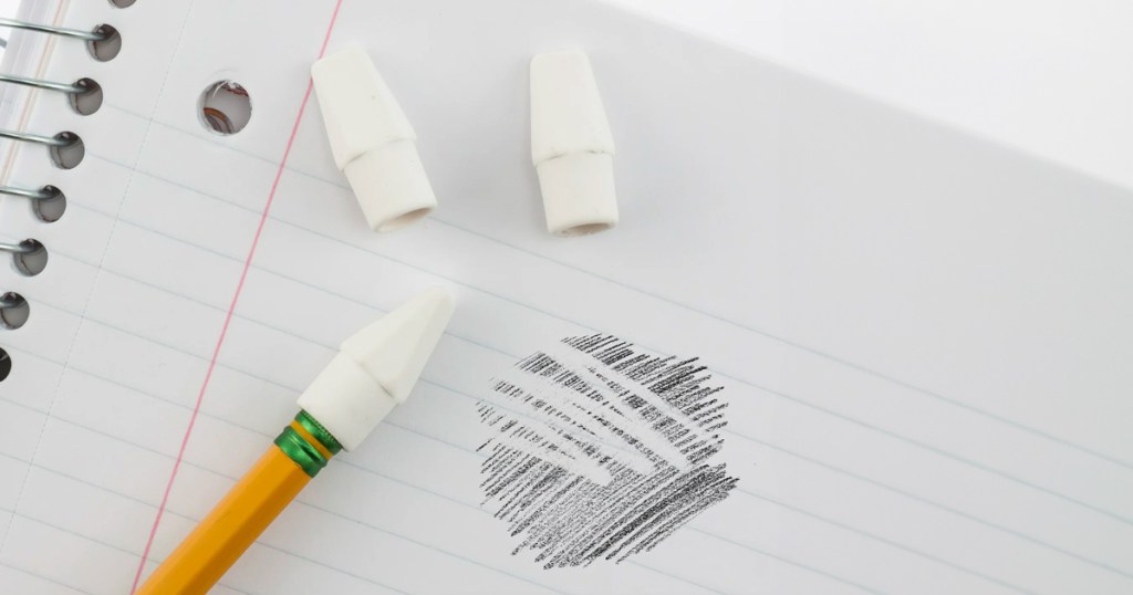 Pentel Hi-Polymer White Cap Erasers being used on a notebook