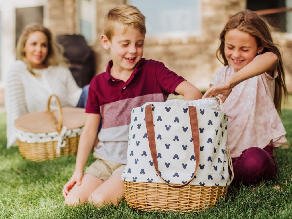 kids reaching into a Picnic Time woven basket bottom canvas tote bag