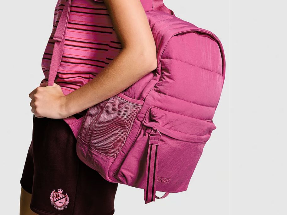 A woman carrying a pink backpack