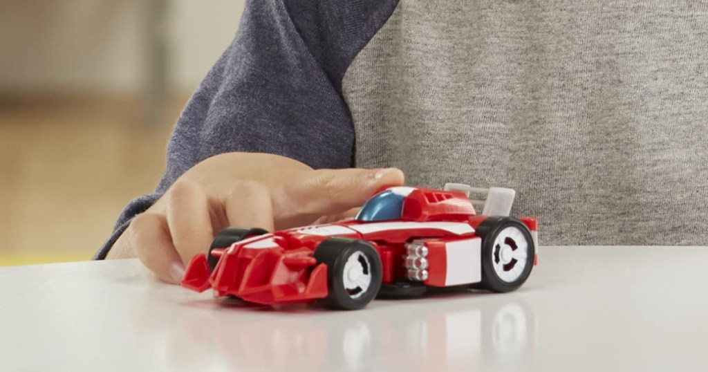 boy playing with red race car toy
