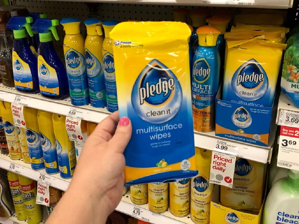 hand holding pack of multi-surface wipes in store
