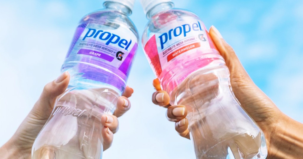 two people holding up propel bottles