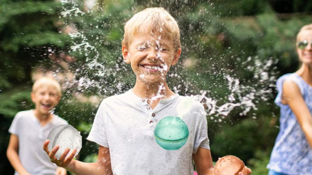 boy playing with water balloon balls