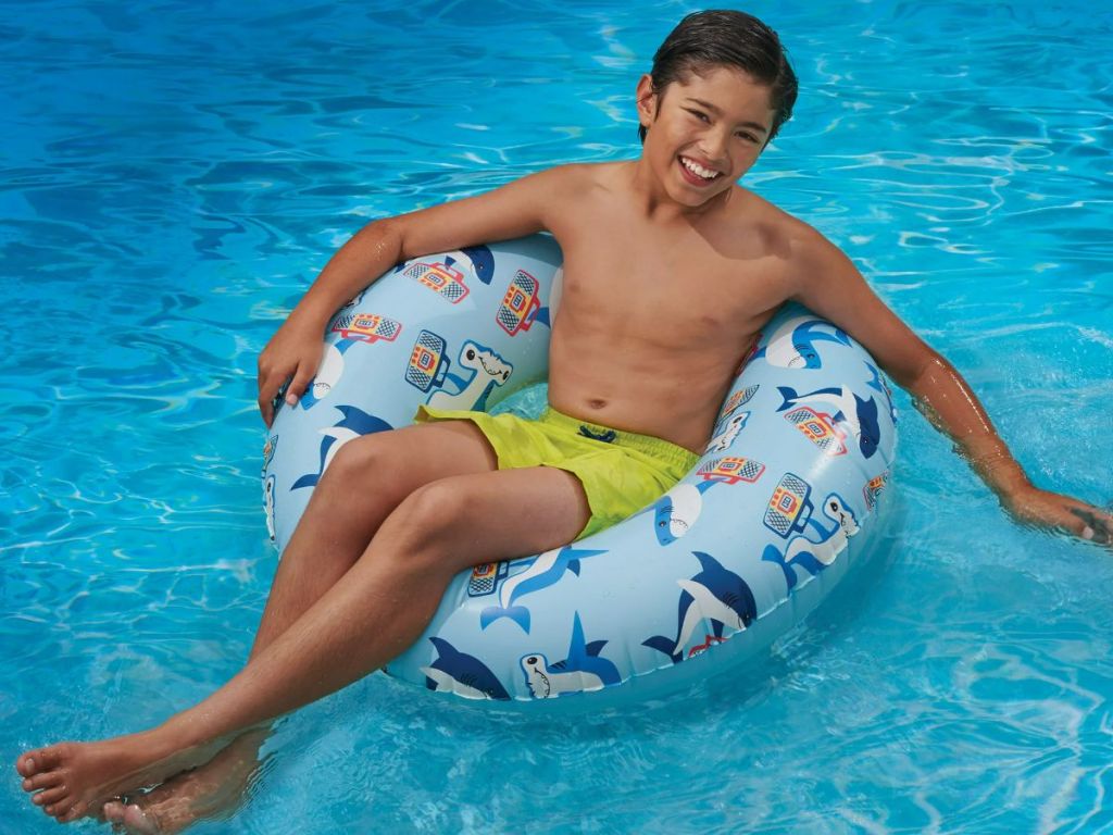 A child in a pool in a blue tube