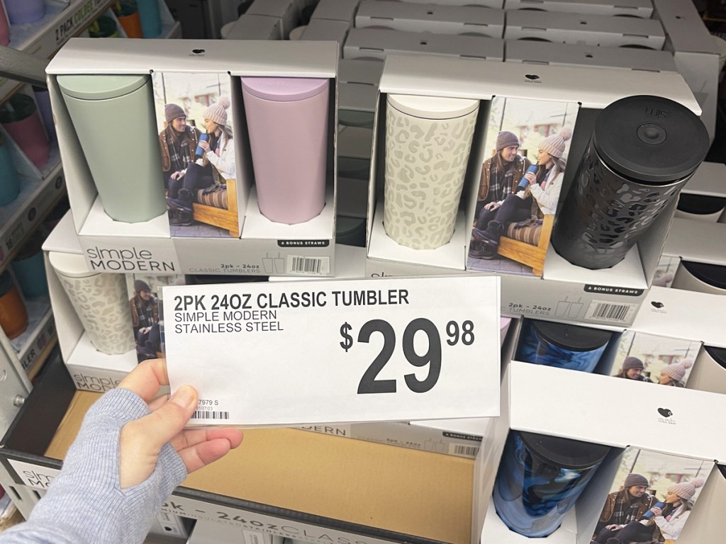 hand holding price tag to simple modern tumblers