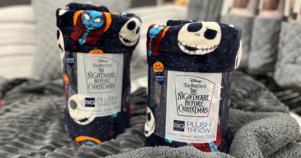 two The Nightmare Before Christmas plush throw blankets on bed in store