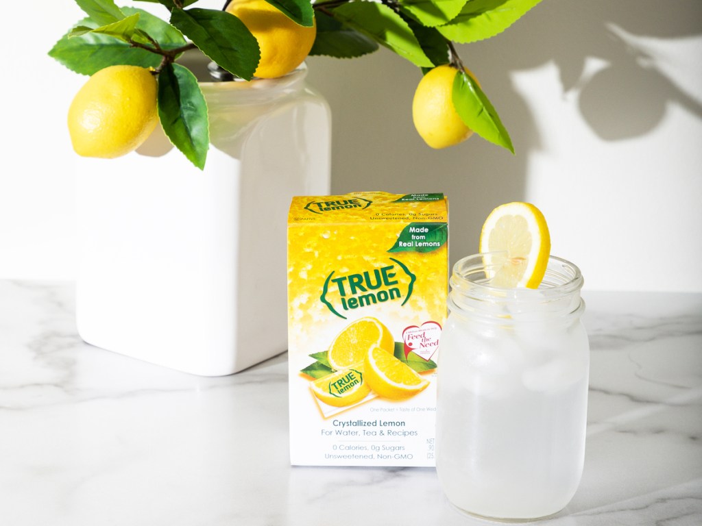true lemon box next to glass on lemonade and lemon tree