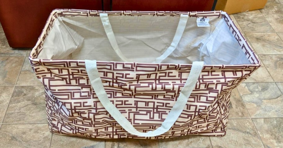 brown and white pattern large tote bag sitting on the floor